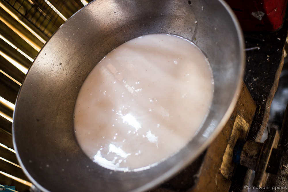 The coconut cream goes into a large wok and is slowly heated